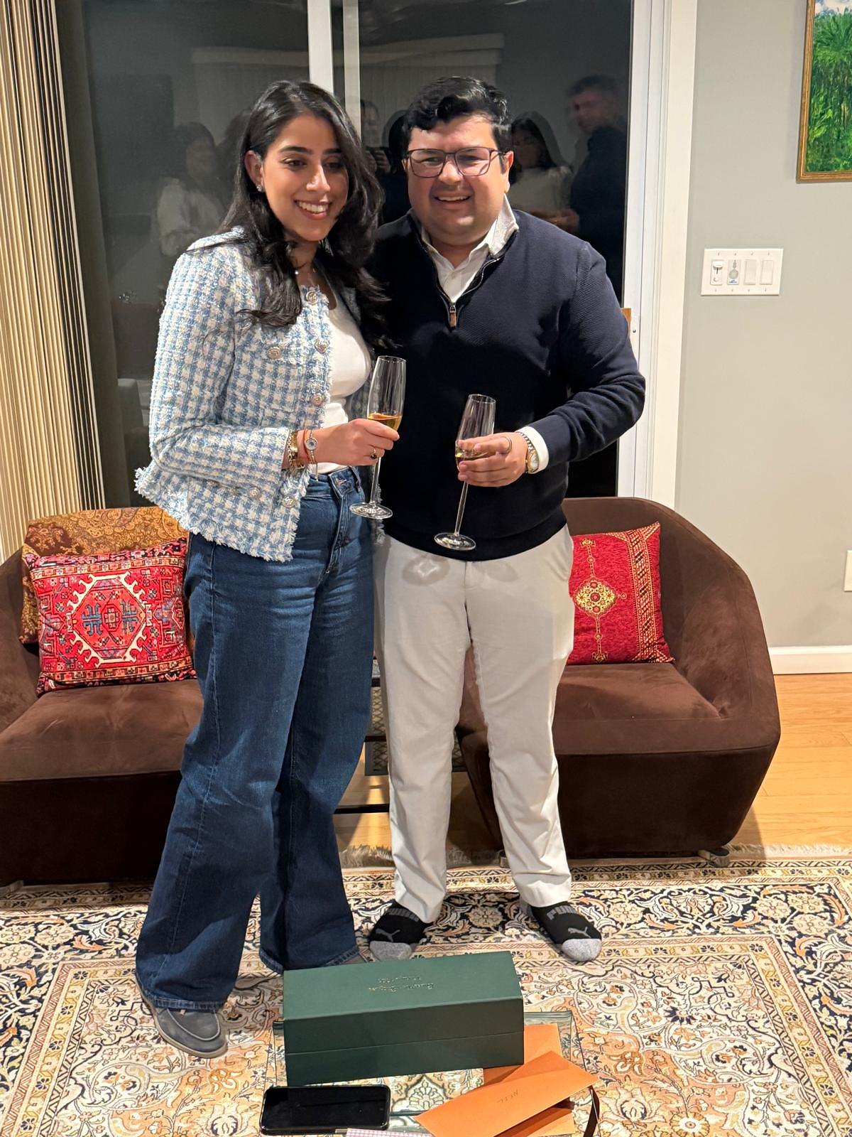 Anaika and Neil celebrating with champagne